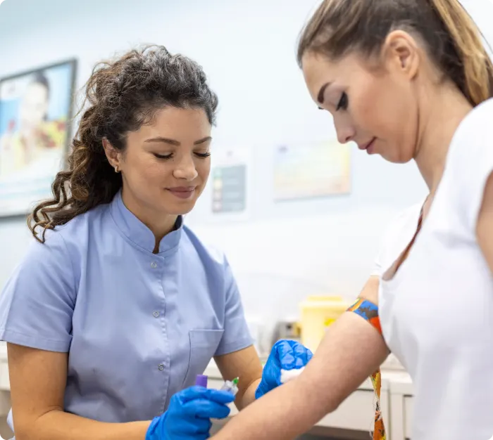 phlebotomist taking a sample image for the team